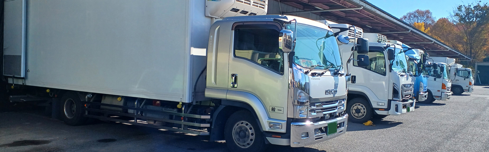 トラックが倉庫から出るヒーロー画像